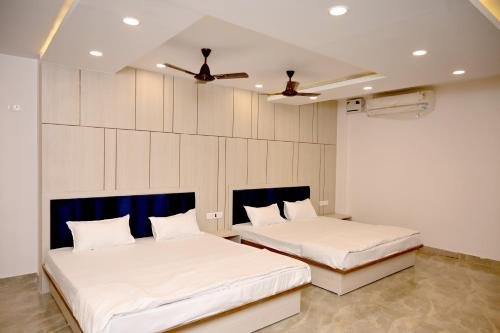 Rambagicha room interior with beds and ceiling fans